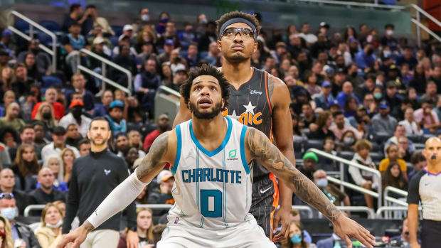 Nov 24, 2021; Orlando, Florida, USA; Charlotte Hornets forward Miles Bridges (0) and Orlando Magic center Wendell Carter Jr. (34) look for the rebound during the second half at Amway Center. Mandatory Credit: Mike Watters-USA TODAY Sports